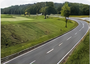 Road lined with revegetated slopes