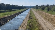 Before: a channelised watercourse, straight between two bare earth dykes.